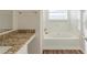 Bathroom featuring granite countertops and a tiled shower-tub combo at 3950 Fennel Sw Cir, Atlanta, GA 30331