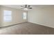 Bright bedroom with two windows, ceiling fan, and neutral-colored walls and carpet at 3950 Fennel Sw Cir, Atlanta, GA 30331