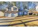 Charming two-story home featuring a two-car garage and manicured front lawn, nestled amongst tall trees at 3950 Fennel Sw Cir, Atlanta, GA 30331