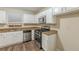 Updated kitchen featuring white cabinets, stainless steel appliances, granite countertops and wood-look flooring at 3950 Fennel Sw Cir, Atlanta, GA 30331