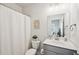 Clean bathroom with a shower/tub combo and gray vanity at 2044 Garvin Rd, Acworth, GA 30101