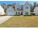 Two-story farmhouse with gray siding, white trim, and a landscaped lawn at 2044 Garvin Rd, Acworth, GA 30101