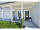 Inviting front porch with white columns, comfortable seating, and potted plants at 2044 Garvin Rd, Acworth, GA 30101