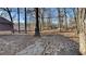 Wooded backyard with gravel pathway and mature trees at 2395 River Run Dr, Douglasville, GA 30135