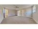 Main bedroom with ceiling fan, neutral walls, and carpet at 2395 River Run Dr, Douglasville, GA 30135