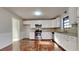Renovated kitchen with white cabinets, granite counters, and hardwood floors at 2395 River Run Dr, Douglasville, GA 30135