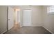 Bedroom with neutral walls, plush carpet, closet, and window with blinds, providing a relaxing retreat at 3418 Longleaf Dr, Decatur, GA 30032