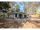 Charming brick home featuring mature landscaping and a convenient carport at 3418 Longleaf Dr, Decatur, GA 30032