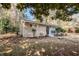 A view of the front yard with mature trees, landscaping, and brick facade at 3418 Longleaf Dr, Decatur, GA 30032