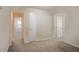 Hallway with neutral paint and carpet leading to bedrooms at 3418 Longleaf Dr, Decatur, GA 30032