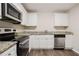 Modern kitchen featuring stainless steel appliances, granite countertops, and ample white cabinetry at 3418 Longleaf Dr, Decatur, GA 30032