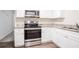 Modern kitchen showcasing stainless steel appliances, granite countertops, and white cabinetry at 3418 Longleaf Dr, Decatur, GA 30032