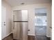 Kitchen with stainless steel refrigerator and view to the living room at 3418 Longleaf Dr, Decatur, GA 30032