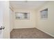 Simple carpeted bedroom with two windows and a closet at 2876 Battle Forrest Dr, Decatur, GA 30034