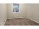 Bright bedroom with neutral walls and carpeting, and a window at 2876 Battle Forrest Dr, Decatur, GA 30034
