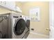 Laundry room with washer, dryer, and built-in shelving at 7434 Woodruff Way, Stone Mountain, GA 30087