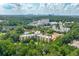 An aerial view of a community with buildings, trees, and a lake, highlighting its serene and natural setting at 1800 Clairmont Lk # 413, Decatur, GA 30033