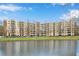 Apartment building with many balconies overlooking water, surrounded by lush trees and greenery at 1800 Clairmont Lk # 413, Decatur, GA 30033