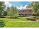 Brick building with a manicured lawn and landscaped walkway with a weeping willow as its focal point at 1800 Clairmont Lk # 413, Decatur, GA 30033