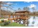 Wooden gazebo on a lake with wooden chairs that provides a relaxing atmosphere for residents to enjoy at 1800 Clairmont Lk # 413, Decatur, GA 30033