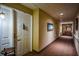 Long hallway with neutral walls, wall decor, and carpet in a residential building at 1800 Clairmont Lk # 413, Decatur, GA 30033