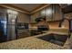 Kitchen with stainless steel appliances, dark wood cabinets, and stone countertops at 1800 Clairmont Lk # 413, Decatur, GA 30033