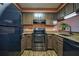 Well-equipped kitchen featuring stainless steel appliances and warm-toned cabinetry at 1800 Clairmont Lk # 413, Decatur, GA 30033