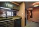 Kitchen features a window, stone countertops, and painted wood cabinetry at 1800 Clairmont Lk # 413, Decatur, GA 30033