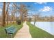 Scenic walking trail by a lake with a bench to enjoy the outdoors and view of the water at 1800 Clairmont Lk # 413, Decatur, GA 30033