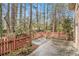 Cozy backyard featuring a private patio area enclosed with a red picket fence, perfect for outdoor enjoyment at 2791 Ponderosa Cir, Decatur, GA 30033