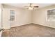 Well-lit bedroom featuring neutral carpet, a ceiling fan, and windows providing natural light at 2791 Ponderosa Cir, Decatur, GA 30033
