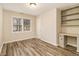 Bright bedroom featuring laminate wood flooring, built-in shelves, and a window with blinds at 2791 Ponderosa Cir, Decatur, GA 30033