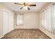 Spacious bedroom with a ceiling fan, closet and sunlit windows dressed with translucent floral curtains at 2791 Ponderosa Cir, Decatur, GA 30033