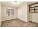 Bedroom featuring neutral colored carpet, a window, and custom shelving at 2791 Ponderosa Cir, Decatur, GA 30033
