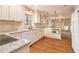 Well-lit kitchen with granite counters, white cabinets, and stainless steel appliances at 2791 Ponderosa Cir, Decatur, GA 30033
