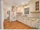 Kitchen with granite counters, stainless range hood, white cabinets, and hardwood flooring at 2791 Ponderosa Cir, Decatur, GA 30033