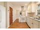 Charming kitchen featuring white appliances, hardwood floors, and stainless steel range hood at 2791 Ponderosa Cir, Decatur, GA 30033