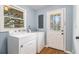 Laundry room with washer, dryer, exterior door and window for natural light at 2791 Ponderosa Cir, Decatur, GA 30033
