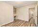 Office space with built-in desk and shelves, laminate floors, and access to bathroom at 2791 Ponderosa Cir, Decatur, GA 30033