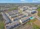 Community overview showing various townhomes, landscaping, and a pool at 413 Delancy Dr, Woodstock, GA 30189