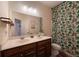 Bathroom with double vanity, shower, and tropical shower curtain at 413 Delancy Dr, Woodstock, GA 30189