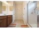 Clean bathroom with double vanity, large mirror, and a walk-in shower at 413 Delancy Dr, Woodstock, GA 30189