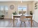 Bright dining room features an oval table with white chairs and a stylish rug at 413 Delancy Dr, Woodstock, GA 30189