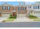 Brick townhome with 2-car garage and landscaped front yard at 413 Delancy Dr, Woodstock, GA 30189