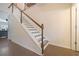 Elegant staircase with wood railings and hardwood floors at 413 Delancy Dr, Woodstock, GA 30189