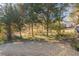 Large backyard with mature trees and partial fence at 551 Garden View Ct, Lawrenceville, GA 30046