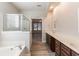 Elegant bathroom with double vanity, soaking tub, and walk-in shower at 551 Garden View Ct, Lawrenceville, GA 30046