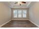 Primary bedroom with ceiling fan and hardwood floors at 551 Garden View Ct, Lawrenceville, GA 30046