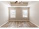 Spacious bedroom with two windows and wood-look flooring at 551 Garden View Ct, Lawrenceville, GA 30046