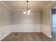 Formal dining room with wainscoting and hardwood floors at 551 Garden View Ct, Lawrenceville, GA 30046